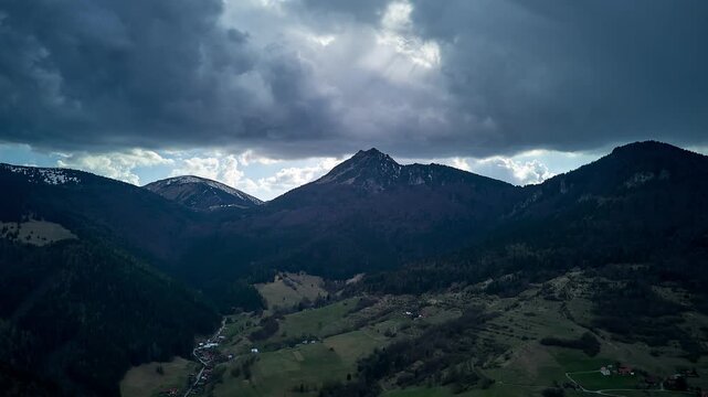 Aerial Hyperlapse of Dramatic Mountain Landscape with Stormy Sky and Green Valley