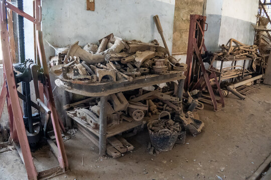 A disorganized pile of spare parts and metal on a bench in the railroad maintenance depot in Asmara, Eritrea