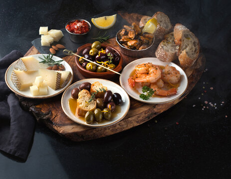 45-degree angle view of Spanish tapas variety presented in a vibrant flat lay arrangement.