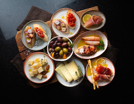 Flat lay view of Spanish tapas variety presented in a vibrant flat lay arrangement.