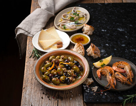 45-degree angle view of Spanish tapas variety presented in a vibrant flat lay arrangement.