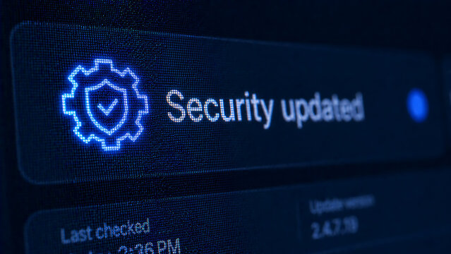 Security system updated notification interface with blue glowing shield and gear icon showing successful software patch installation on computer