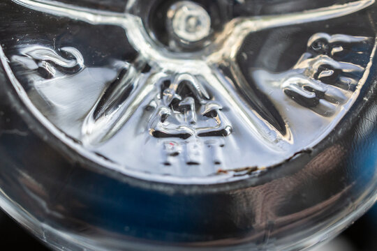 Closeup of PET recycling symbol on clear plastic bottle sustainability and plastic waste concept