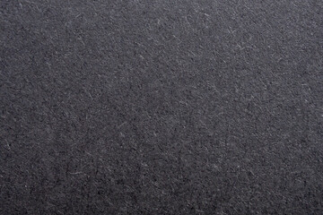 Fototapeta premium Black paper texture background with rough fiber surface and dark grey cardboard pattern