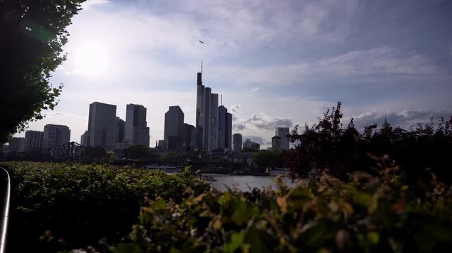 Frankfurt Skyline with Commerzbank Tower Revealed Through Green Foliage
