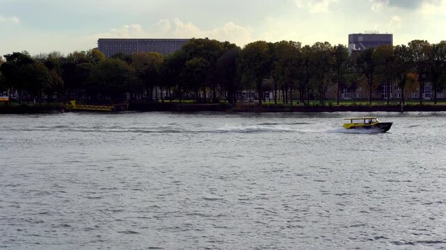 Yellow Rotterdam Water Taxi Crossing Nieuwe Maas River, Netherlands