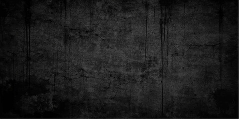 Fototapeta premium A dark aged concrete wall texture with a rough vintage grunge effect creates a dirty black and gray textured backdrop for a blank industrial design