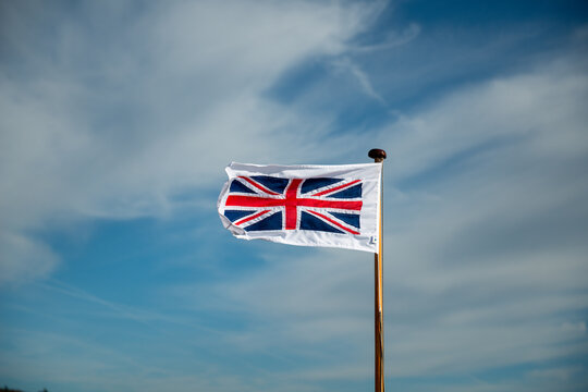 English flag, red cross on white on the Bow of a boat on a lake
