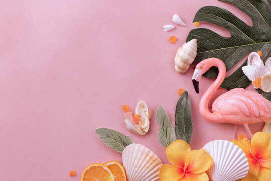 Summer tropical background with copy space for a text, pink flamingo with monstera leaves.