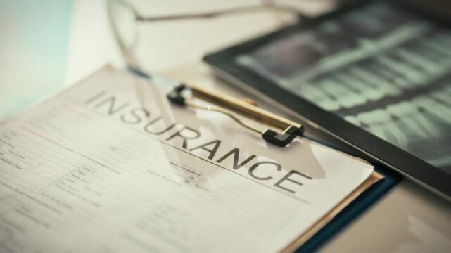 A dentist presents an insurance form, detailing medical insurance coverage for dental treatment. The healthcare document clarifies benefits, guiding patients through the claim process