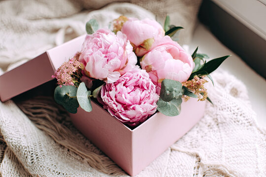 Beautiful gift box with pink peonies. Concept of internet shopping, flower shop. Flowers composition for Valentine's, Mothers or Women's Day 