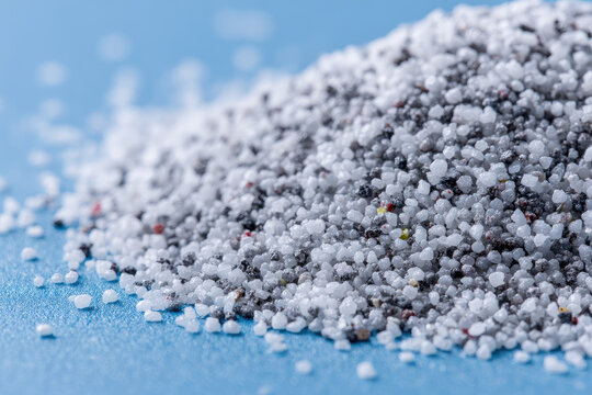 Many white and gray granules of polypropylene, polyamide. Background. Plastic and polymer industry, industry. Microplastic products. 