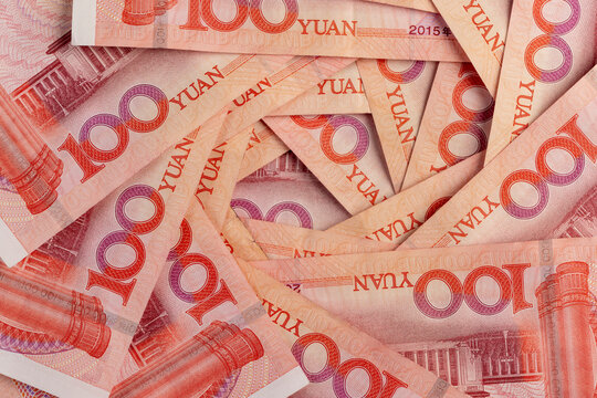 red Chinese cash in denominations of one hundred yuan, heap of paper Chinese banknotes in denominations of 100 yuan, The money is folded in the shape of a fan