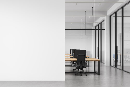 Minimal modern office interior with empty white wall mockup beside open workspace featuring clean lines and contemporary architecture for design presentation. 3D Rendering