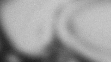 This image presents striking monochrome abstract composition featuring liquid wave form layered with heavy grain noise texture. The visual flows through spectrum of black charcoal and light gray © umaporn