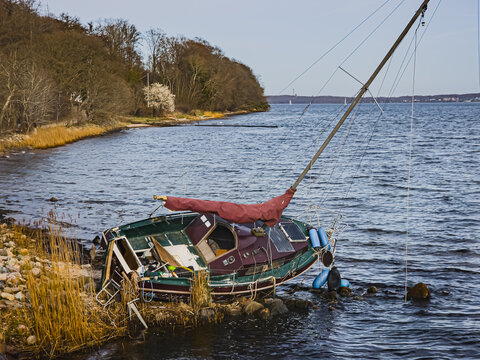 Damaged boat on shoreline near Flensburg Germany April 8, 2026