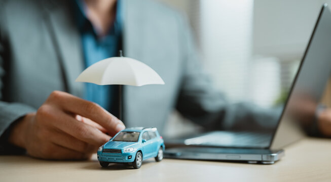 Car insurance concept with vehicle protected by umbrella symbolizing risk coverage, financial protection, and policy security, representing auto insurance services, liability coverage.