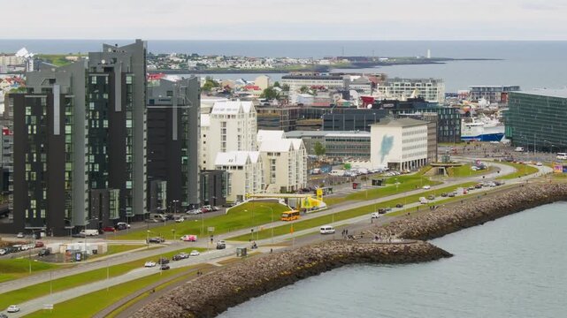Reykjavik, Iceland. Aerial view of the city center of Reykjavik, Iceland during a cloudy day in summer. Time-lapse with car traffic in downtown, panning video