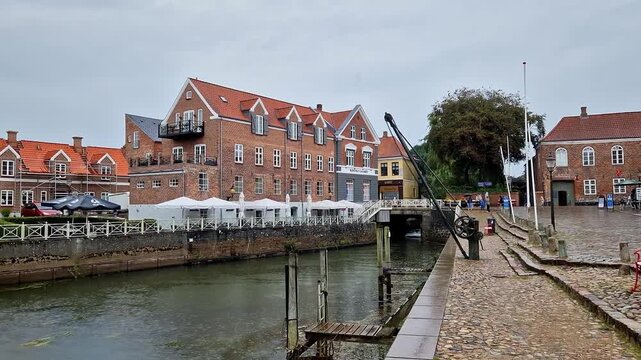 Historic Brick Building with Waterfront Cafe Along Canal Bridge, Ribe, Denmark
