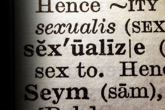 Word sexualize on dictionary page, macro close up