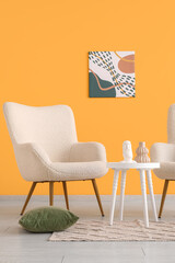 Fototapeta premium Comfortable armchair and coffee table near orange wall in interior of living room