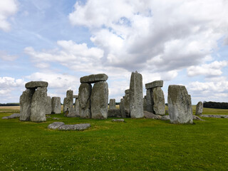 Naklejka premium The stonehenge on green meadow under a blue sky landscape