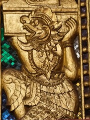 Fototapeta premium Golden Guardian: A close-up view of an intricate golden sculpture. This image showcases the detailed artistry and cultural significance.