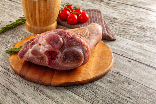 Raw pork knuckle over board
