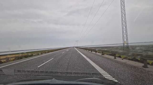 Driving POV on Straight Coastal Road Through Flat Marshlands near Ribe