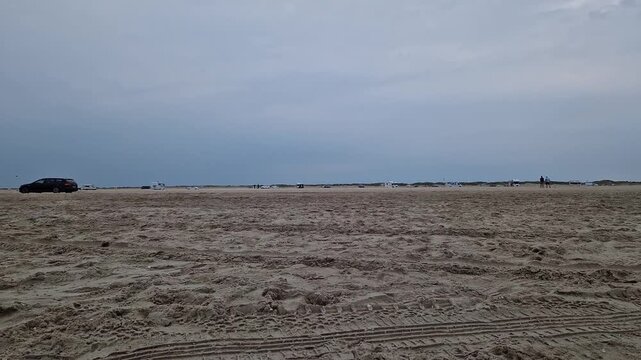 White Van Parked on Wide Sandy Beach near Ribe, Jutland, Denmark