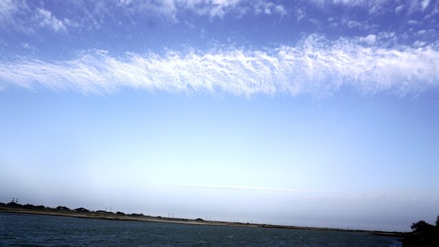 Vast sky filled with delicate cirrus clouds above the Syr Darya river, Kyzylorda.