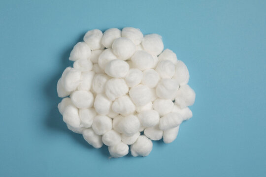 Soft cotton balls pile, top view. Macro detail cotton wool for facial cleansing. Hygiene and skincare beauty product backdrop