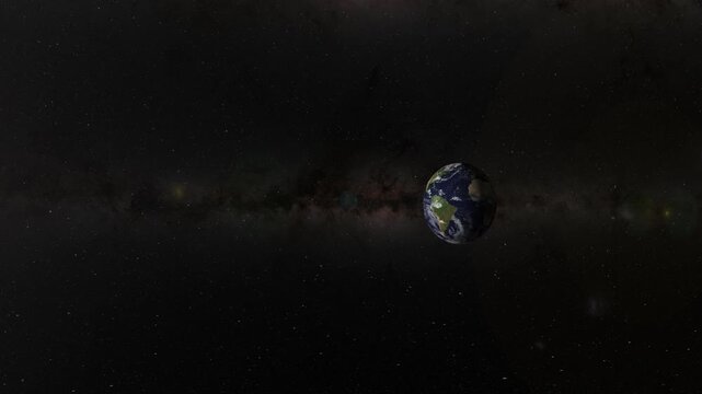 Dynamic zoom in toward planet earth rotating in dark space with milky way galaxy background.