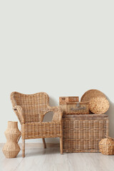 Fototapeta premium Interior of stylish living room with rattan armchair and different wicker baskets