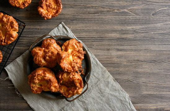 Yorkshire puddings on plate on wooden table