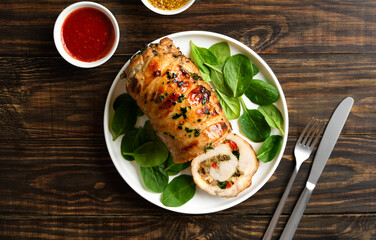 Fototapeta premium Delicious roasted pork roll stuffed with mushroooms, onion, red bell pepper, spinach