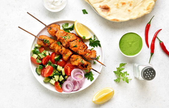 Tandoori chicken skewers served with fresh vegetables