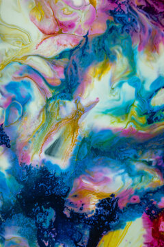 Colorful abstract design with pink, blue, and yellow shapes blending together in a vivid display of texture and layers