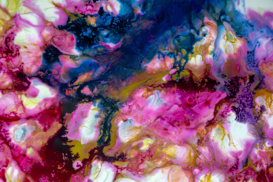 Colorful abstract design with pink, blue, and yellow shapes blending together in a vivid display of texture and layers