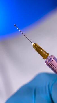 Super Slow Motion Syringe Needle With Droplet Poised At Tip
