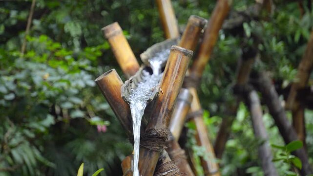 Rustic Waterwheel Beside a Natural Spring in a Peaceful Countryside Setting