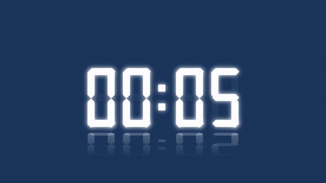 A digital clock with glowing white numbers counts down the seconds with a clear reflection on the surface