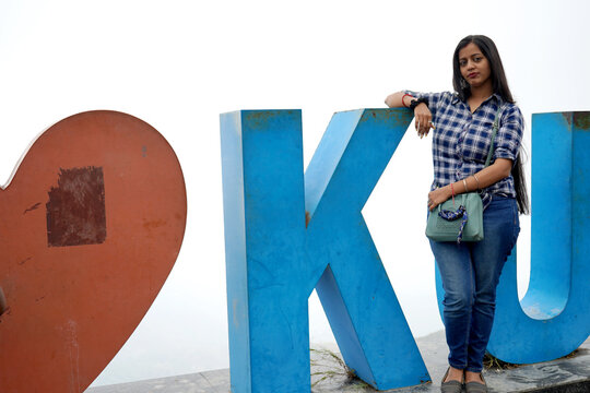 Young Indian Woman Posing At The I Love Kurseong Sign In The Himalayas