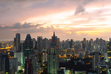 Obraz premium BANGKOK, THAILAND - AUGUST 15, 2015: A panoramic high-angle view captures the dense urban landscape of Bangkok's business district during the early morning sunrise.