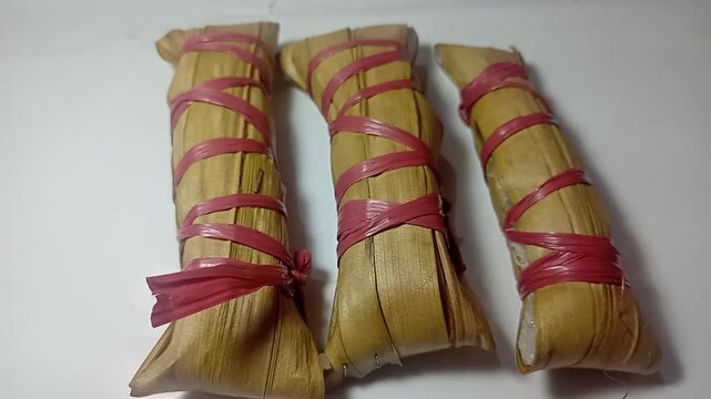 Indonesian Traditional Cake Lepet Made of Sticky Rice and Coconut Milk on White Background