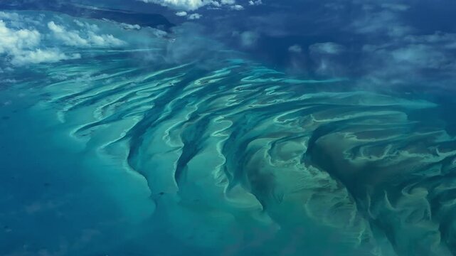 flying across turquoise water surface, cays and a small atolls in The Bahamas, located in the Caribbean Sea in Atlantic Ocean - 4k aerial video footage