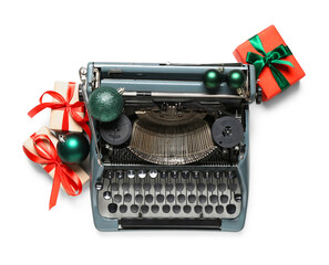Naklejka premium Vintage typewriter with Christmas balls and gift boxes on white background. Top view