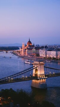 Experience the beauty of Budapest at dusk. The enchanting scenery showcases the famous bridges and grand buildings reflected on the shimmering Danube River, perfect for travel inspiration.