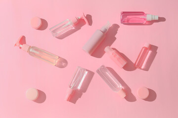 Naklejka premium Composition with different travel cosmetic products on pink background