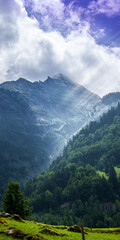 Obraz premium Dramatic crepuscular rays over the Engelhörner mountain range in Haslital valley near Meiringen, Bernese Oberland, Switzerland.